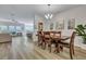 Elegant dining area with hardwood floors, stylish lighting, and seamless flow into living spaces at 131 Swaying Palm Dr, Summerville, SC 29485
