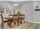 Well-lit dining room with hardwood floors, decorative art, and a cross adding character to the space at 131 Swaying Palm Dr, Summerville, SC 29485
