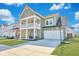 Charming two-story home featuring a welcoming front porch and well-manicured lawn at 131 Swaying Palm Dr, Summerville, SC 29485