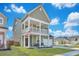 Beautiful two-story home with a charming front porch and well-kept landscaping at 131 Swaying Palm Dr, Summerville, SC 29485
