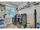 Well-lit laundry room featuring modern appliances and ample storage shelving for convenience at 131 Swaying Palm Dr, Summerville, SC 29485