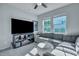 Bright living room with a large TV, and a sectional sofa at 131 Swaying Palm Dr, Summerville, SC 29485