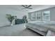 Inviting main bedroom with large windows, plush carpet, ceiling fan, and decor elements at 131 Swaying Palm Dr, Summerville, SC 29485