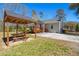 Backyard featuring a wooden pergola with a picnic table and partial view of the home at 146 Picard Dr, Ladson, SC 29456