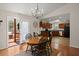Cozy dining area features a wooden table, chandelier, and open access to the kitchen and outdoor deck, blending indoor-outdoor living at 146 Picard Dr, Ladson, SC 29456
