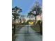 Gated driveway entry to a property featuring a well-lit garage, perfect for security and privacy at 146 Picard Dr, Ladson, SC 29456