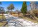 Long concrete driveway leading to a gated property with lush green surroundings at 146 Picard Dr, Ladson, SC 29456