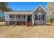 Charming one-story home featuring a welcoming front porch and light-gray siding at 146 Picard Dr, Ladson, SC 29456