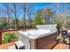 Relaxing hot tub on wooden deck, perfect for outdoor leisure and entertaining, surrounded by trees and backyard scenery at 146 Picard Dr, Ladson, SC 29456