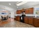 Open kitchen with wooden cabinets, black appliances, and connection to dining area, perfect for cooking and entertaining guests at 146 Picard Dr, Ladson, SC 29456
