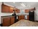 Well-lit kitchen boasts wooden cabinets, stainless steel appliances, and a functional layout, perfect for culinary enthusiasts at 146 Picard Dr, Ladson, SC 29456
