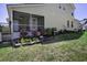 Home featuring a backyard and screened-in back porch with beautiful landscaping and rock border at 156 Woodward Rd, Goose Creek, SC 29445