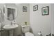 Charming half-bathroom with pedestal sink, decorative mirror, and stylish wall art at 156 Woodward Rd, Goose Creek, SC 29445