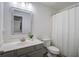 Bright bathroom with a single vanity, mirror, toilet, and a shower with curtain at 156 Woodward Rd, Goose Creek, SC 29445