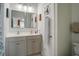 Bright bathroom featuring a double sink vanity, mirrors, and a door with a hanging device at 156 Woodward Rd, Goose Creek, SC 29445