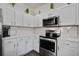 Bright kitchen with stainless steel appliances, white cabinets, subway tile backsplash, and modern oven and microwave at 156 Woodward Rd, Goose Creek, SC 29445