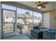 View of screened porch including seating, ceiling fan, and open views of the backyard at 156 Woodward Rd, Goose Creek, SC 29445