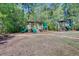 Community playground with train-shaped structure, slides, and other play equipment surrounded by lush greenery at 156 Woodward Rd, Goose Creek, SC 29445