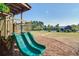 Close-up of playground slides, with views of the community pool and clubhouse in the background on a clear day at 156 Woodward Rd, Goose Creek, SC 29445