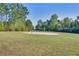 Outdoor sand volleyball court surrounded by mature trees in common area at 156 Woodward Rd, Goose Creek, SC 29445