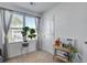 Cozy bedroom with a large window, carpeted floor, and decorated with plants and photos at 158 Spencer Cir, Summerville, SC 29485