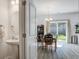 Open concept dining area with modern lighting fixture, and sliding glass doors leading to backyard at 158 Spencer Cir, Summerville, SC 29485