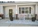 Inviting front porch with white stone detail and decorative welcome sign at 158 Spencer Cir, Summerville, SC 29485