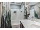 Well-lit bathroom featuring a shower-tub combo, white tile, and neutral gray paint at 1587 Bluewater Way, Charleston, SC 29414