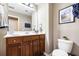 Bright bathroom with a dark wood vanity, toilet, and updated fixtures at 1587 Bluewater Way, Charleston, SC 29414