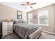 Cozy bedroom featuring a queen bed, ceiling fan, and two bright windows at 1587 Bluewater Way, Charleston, SC 29414
