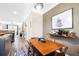 Dining room with modern decor, wood table, lighting, and view to kitchen and living room at 1587 Bluewater Way, Charleston, SC 29414