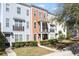 Charming multi-story townhome showcasing a front porch and balcony, with neat landscaping and vibrant curb appeal at 1587 Bluewater Way, Charleston, SC 29414