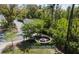 A lovely community fire pit and seating area is surrounded by lush landscaping and mature trees at 1587 Bluewater Way, Charleston, SC 29414