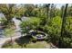 A lovely community fire pit and seating area is surrounded by lush landscaping and mature trees at 1587 Bluewater Way, Charleston, SC 29414