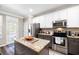 Modern kitchen featuring granite countertops, stainless steel appliances, and an island at 1587 Bluewater Way, Charleston, SC 29414