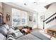 Bright living room featuring large windows, a comfortable sofa, and stylish decor at 1587 Bluewater Way, Charleston, SC 29414