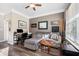 Comfortable living room with natural light, a workspace, and cozy seating at 1587 Bluewater Way, Charleston, SC 29414