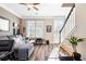 Cozy living room with large windows, comfortable seating, and a staircase at 1587 Bluewater Way, Charleston, SC 29414