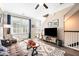 Cozy living room featuring hardwood floors, modern decor, and natural light filtering through the French doors at 1587 Bluewater Way, Charleston, SC 29414