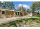 Brick home features a spacious backyard with a concrete patio and mature trees providing ample shade at 159 Foxborough Rd, Goose Creek, SC 29445