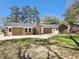 A backyard featuring a full brick house, an expansive concrete patio and a quaint grassy area for outdoor enjoyment at 159 Foxborough Rd, Goose Creek, SC 29445