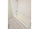 White tiled bathtub and shower with patterned floor tiles in a renovated bathroom at 159 Foxborough Rd, Goose Creek, SC 29445