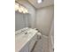 Bright bathroom featuring decorative floor tiles, a white vanity, and a bath tub with tile surround at 159 Foxborough Rd, Goose Creek, SC 29445