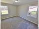 Bedroom featuring neutral carpet, light walls, and two windows letting in natural light at 159 Foxborough Rd, Goose Creek, SC 29445