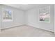 Bright bedroom with plush carpeting, neutral paint, and large windows offering natural light and neighborhood views at 159 Foxborough Rd, Goose Creek, SC 29445