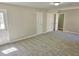 Spacious carpeted bedroom with a door and multiple closet doors at 159 Foxborough Rd, Goose Creek, SC 29445