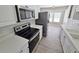 Modern kitchen with stainless steel appliances, white cabinets and countertops, and vinyl plank flooring at 159 Foxborough Rd, Goose Creek, SC 29445
