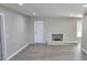 Open living room featuring a fireplace and gray vinyl plank flooring throughout the space at 159 Foxborough Rd, Goose Creek, SC 29445