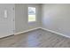 Sunlit living room boasts neutral paint, vinyl plank flooring, and a large bright window at 159 Foxborough Rd, Goose Creek, SC 29445