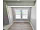 Cozy room with a large window offering natural light and views, vinyl plank flooring, and a painted brick element at 159 Foxborough Rd, Goose Creek, SC 29445